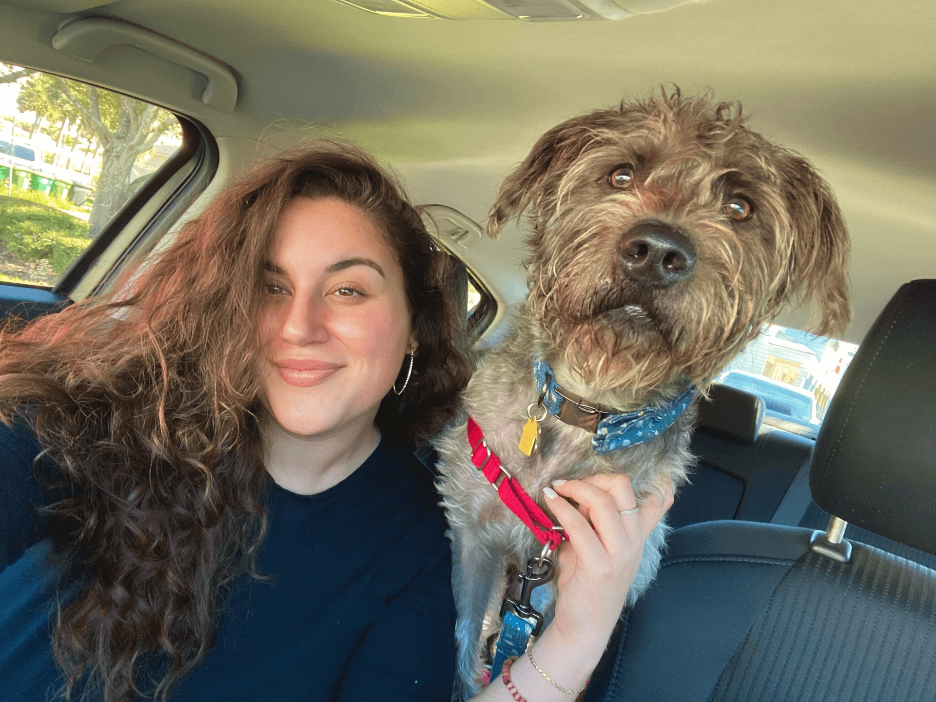 Nicole with her dog Toni, taking a selfie together in the car